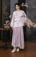 Model styling the smoky pink jacquard jacket with a coordinating pleated skirt.
