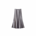 Flat lay of a smoky purple satin A-line maxi skirt with a high waist and smooth flowing drape, crafted from 100% polyester.