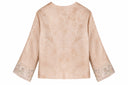 Back view of the soft peach pink jacket, showing its tonal floral pattern and embroidered cuffs.