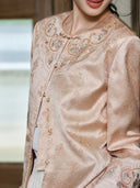 Close-up on a model showing the jacket’s embroidered round neckline and loop-and-button closures.