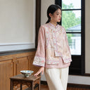 Three-quarter view of the pink-gold vest layered over a smoky pink top beside a window.