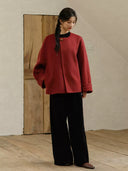 Suian red wool and camel hair coat styled with a black top and black wide-leg trousers