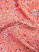 Close-up of the crimson, pink and metallic-toned jacquard fabric