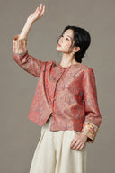Model wearing the jacket with a cream skirt and one arm raised