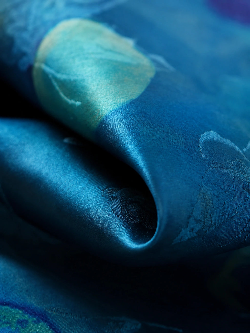 Close-up of lustrous vintage blue Xiangyunsha silk with tonal polka dot motifs