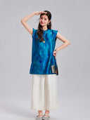 Woman wearing a vintage blue polka dot Xiangyunsha silk top with ruffled shoulders