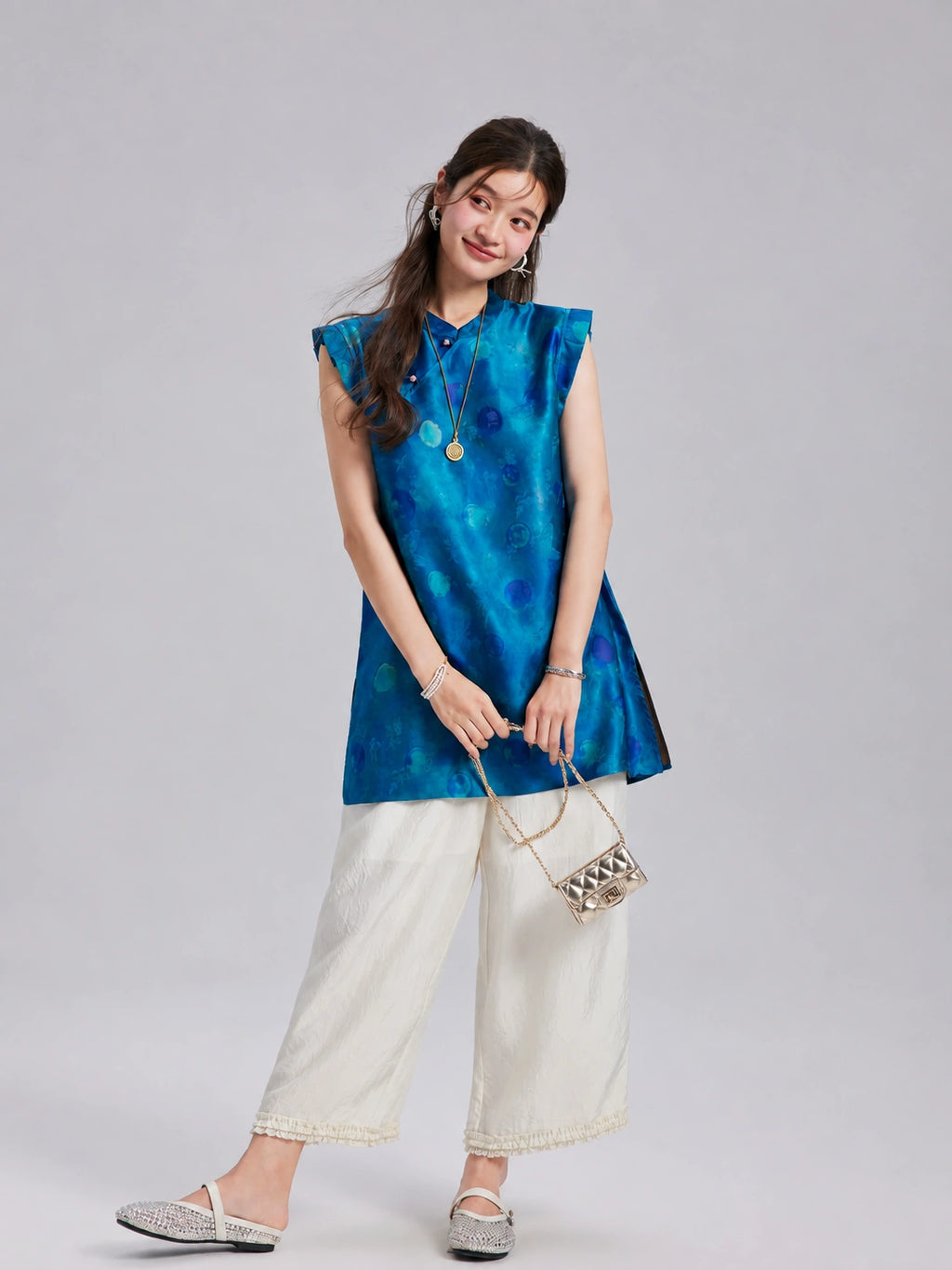 Front view of a relaxed vintage blue Xiangyunsha silk top with tonal circular motifs