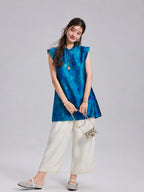 Front view of a relaxed vintage blue Xiangyunsha silk top with tonal circular motifs
