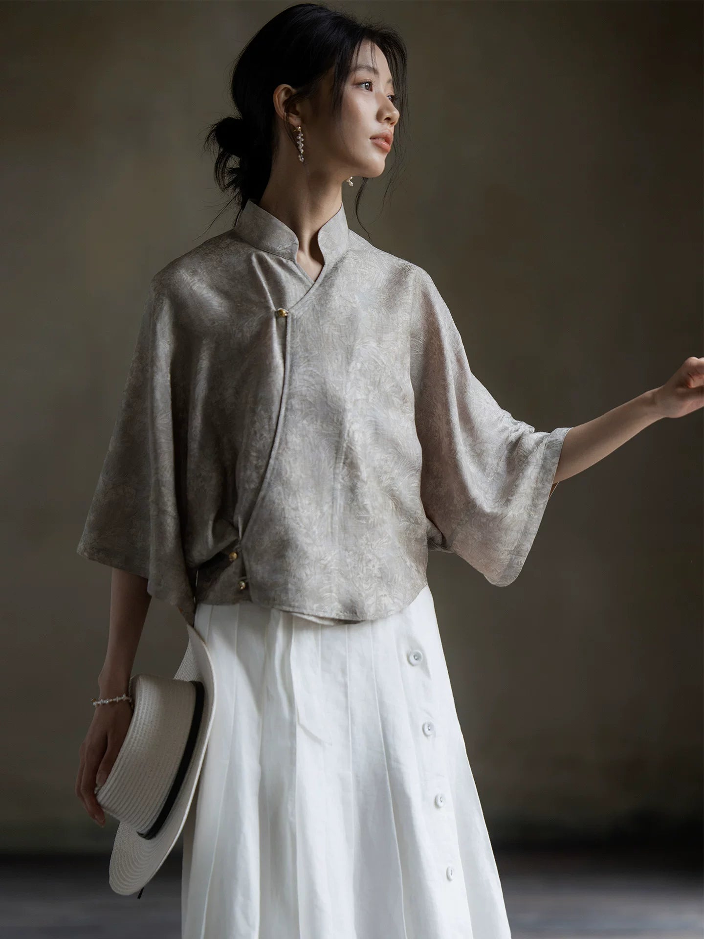 Lifestyle image of the Warm Mist Mandarin collar blouse with wide sleeves.
