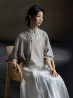 Seated portrait featuring the Warm Mist jacquard crossover blouse.