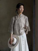 Relaxed fit Warm Mist jacquard blouse styled with a white button-front skirt.