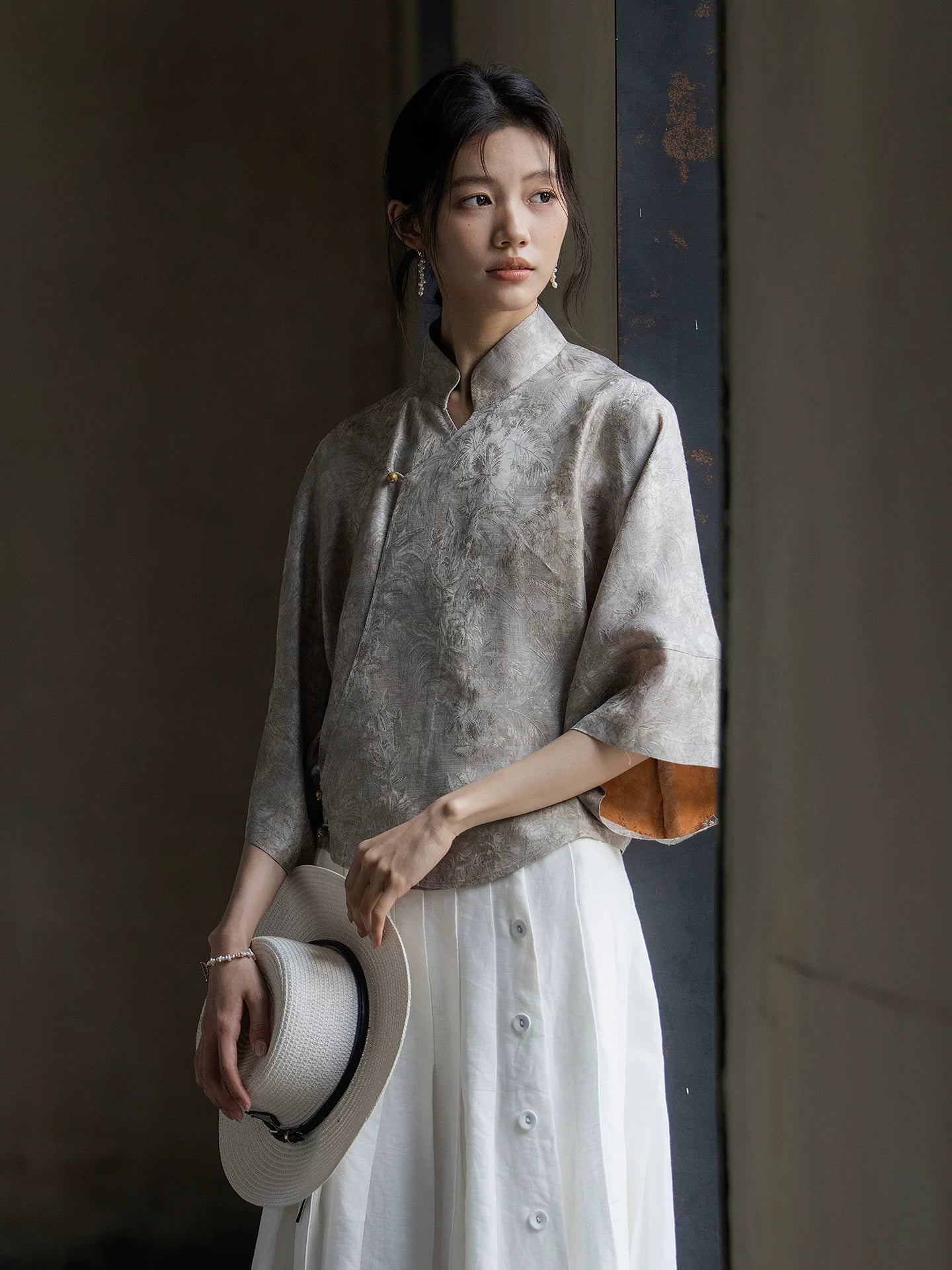 Side view of a Warm Mist Mandarin collar jacquard blouse in natural light.