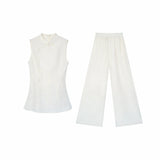 Flat lay of a white wide-leg pants and top set in New Chinese style, featuring a mandarin collar and elastic waistband.