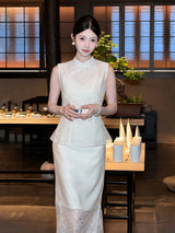 Front view of a white Qipao blouse and A-line skirt set with lace details, worn by a model holding a teacup in a traditional interior.