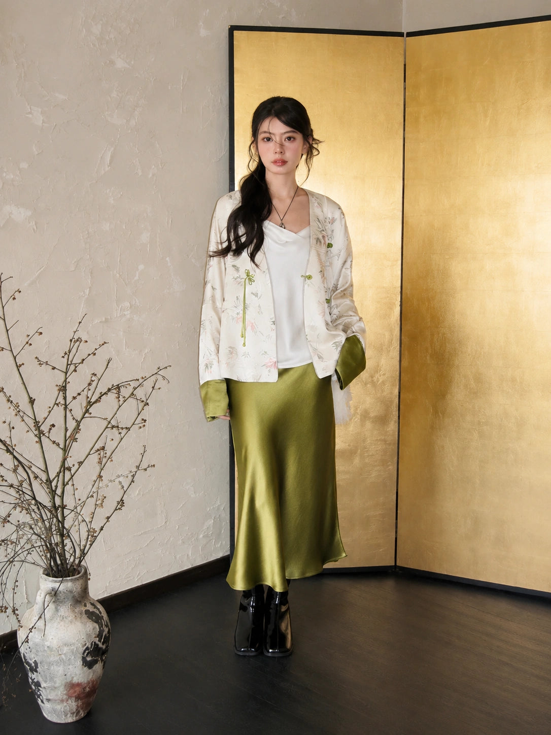 Front view of a white green bamboo-pattern acetate jacket paired with a matcha green acetate skirt for an elegant commuter outfit.