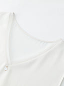 Close-up of the V-neckline on a white silk blend vest, showcasing the fine stitching, delicate edge, and the 100% mulberry silk trim detail.