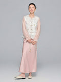 Full body shot of a model wearing a white New Chinese style Tencel vest over a pink sheer blouse and satin midi skirt, showcasing the elegant and graceful aesthetic.
