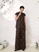 Front view of a wine red silk Cheongsam co-ord set featuring a mandarin collar short sleeve top and matching wide-leg trousers, crafted from 100% mulberry silk with green brocade pattern.