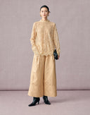 Women’s beige jacquard wide-leg pants styled with a coordinating lace blouse