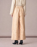 Back view of women’s beige jacquard cropped pants with a comfortable gathered waistband