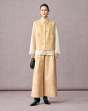 Woman wearing beige New Chinese jacquard wide-leg pants with a matching embroidered vest