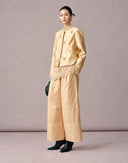 Side view of women’s beige jacquard wide-leg pants with a structured cropped silhouette