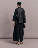 Back view of the black side of the reversible silk jacket
