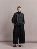 Full-length outfit featuring the black crackle-pattern silk jacket