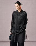 Woman wearing a black New Chinese jacquard shirt and wide-leg pants set with an asymmetric layered design