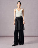 Front view of black jacquard wide-leg pants with an elastic waist and layered sheer panel