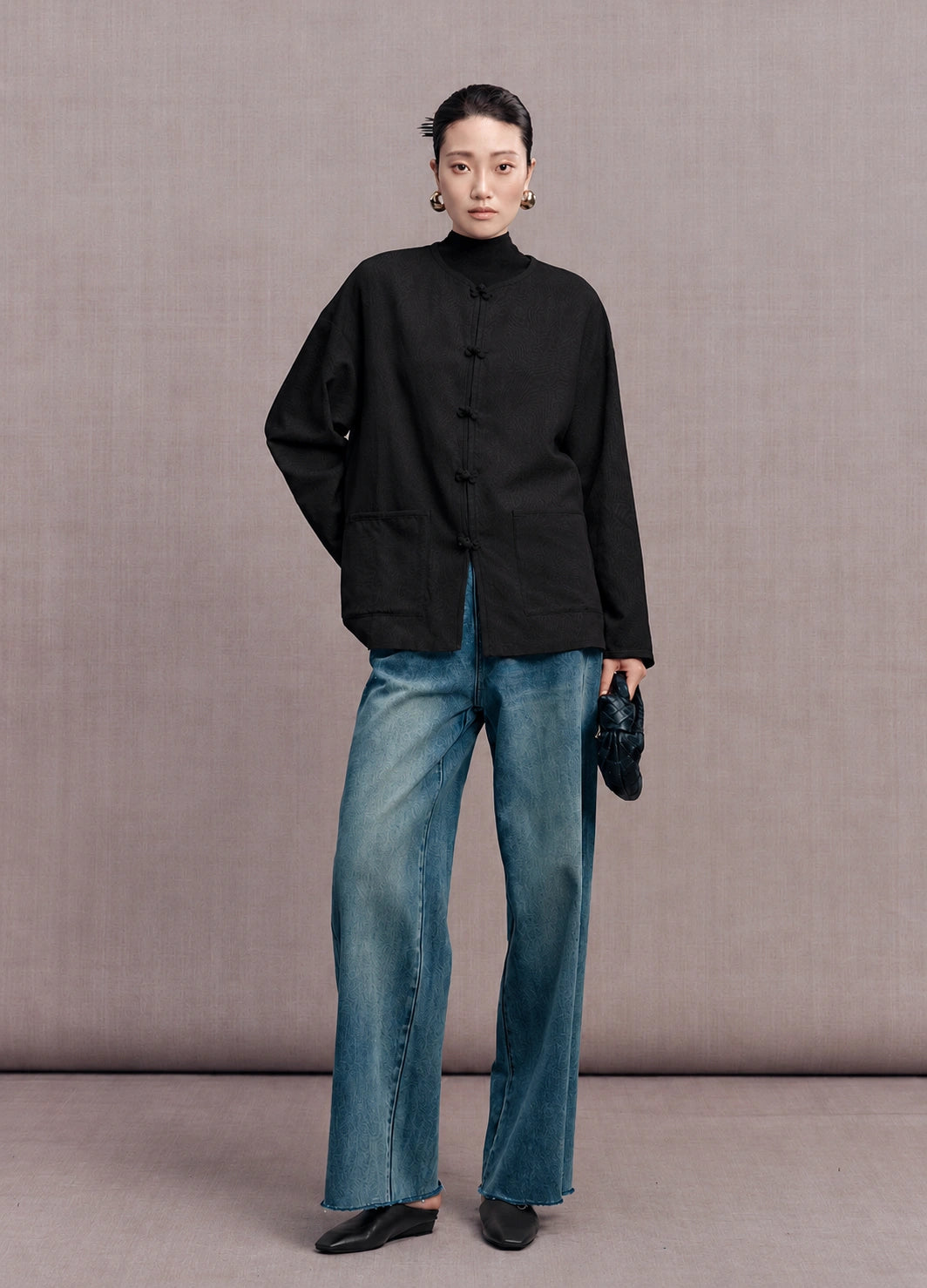 Full-length look featuring the black New Chinese frog-button jacket styled with blue jeans