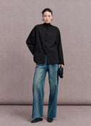 Full-length look featuring the black New Chinese frog-button jacket styled with blue jeans
