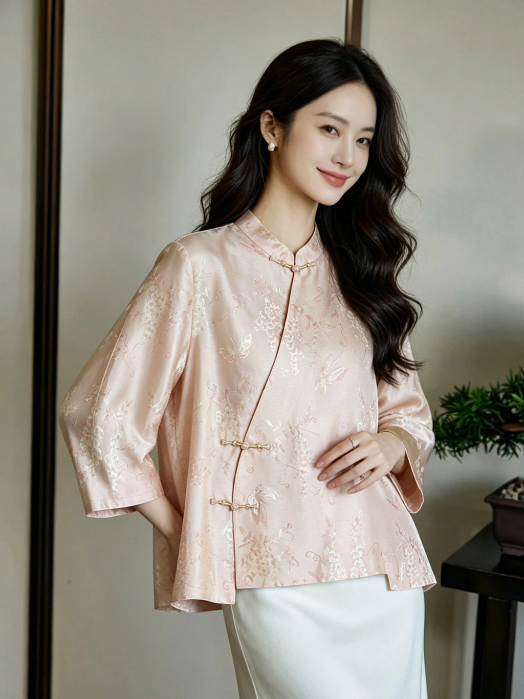 Front view of a relaxed blush pink jacquard silk top with asymmetric frog-button closures