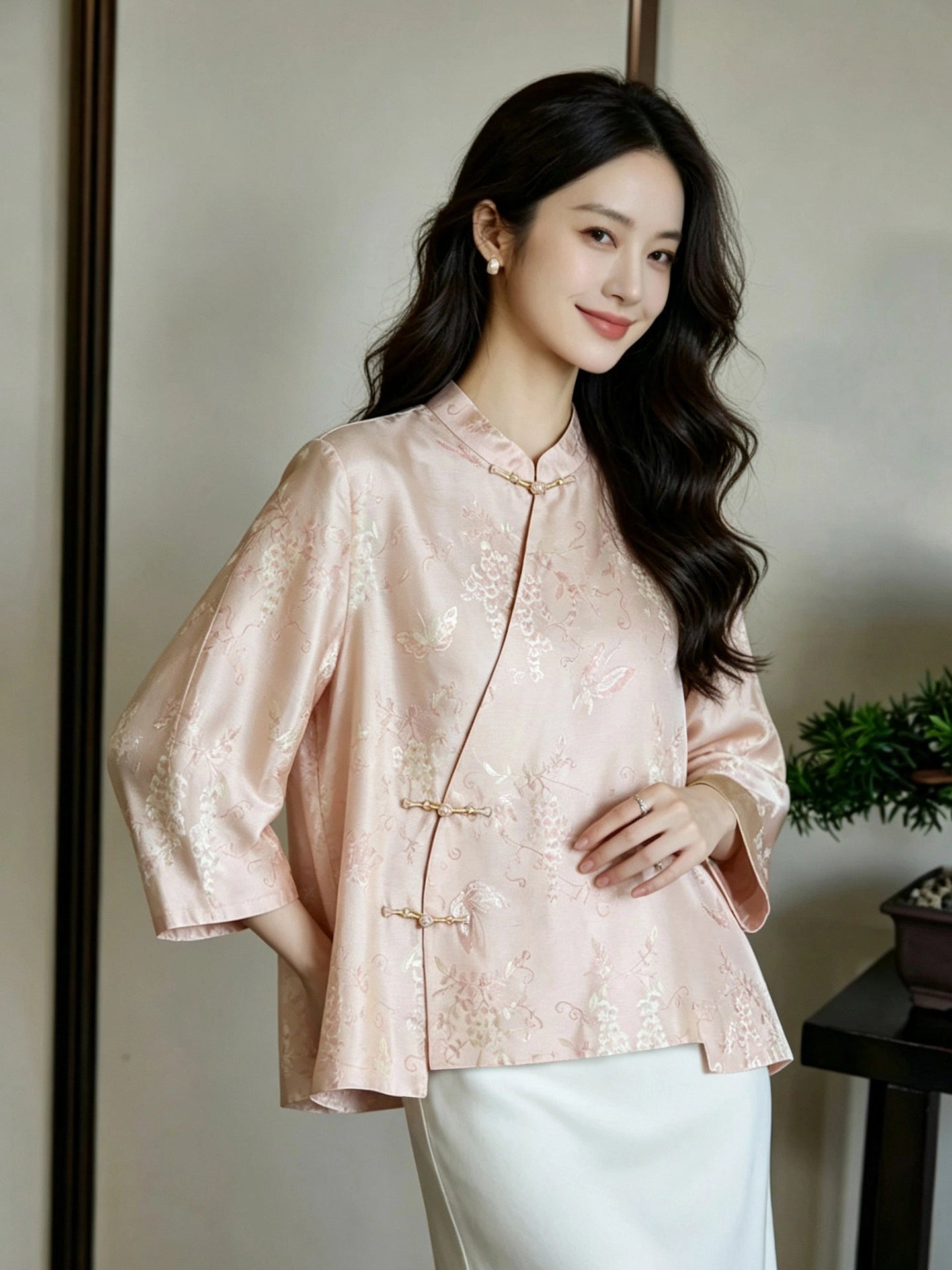 Front view of a relaxed blush pink jacquard silk top with asymmetric frog-button closures