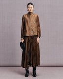 Full-length look featuring the bronze brown butterfly vest with a pleated skirt