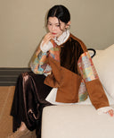 Brown velvet and brocade jacket styled over a white ruffled blouse