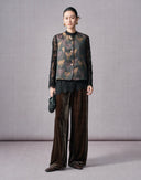 Dark brown silk velvet wide-leg pants styled with a patterned vest and black lace top