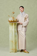 Full-length styling of the gold-accented embroidered linen jacket and maxi skirt
