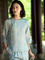 Front view of a relaxed light blue mulberry silk blouse with a round neck and three-quarter sleeves