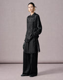 Side view of a women’s black New Chinese jacquard outfit with a loose shirt and flowing trousers