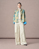 Full-length styling of a women’s New Chinese jacquard jacket with ivory wide-leg trousers