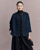 Front view of the navy side of a women’s reversible Xiangyunsha silk jacket with button closure