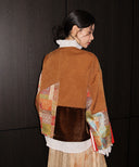 Back view showing the jacket’s brown fabric, velvet panel and multicolored brocade sections