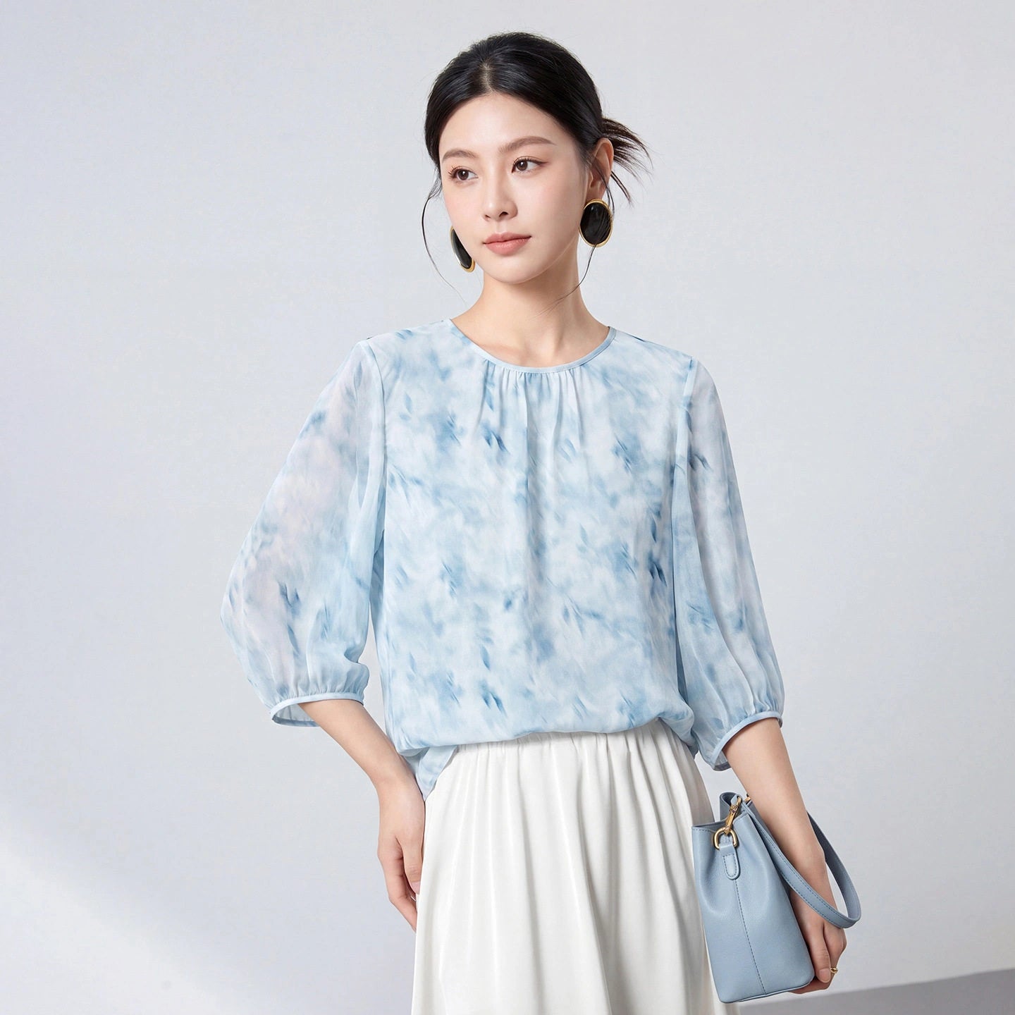 Sky blue 100% mulberry silk blouse styled with a white skirt and blue handbag