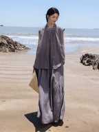 Full-length view of a women’s summer two-piece set with a sleeveless top and long asymmetric skirt.