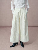 Front view of women’s white jacquard cropped wide-leg pants with a high waist and side pockets