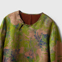 Close-up of the round neckline and asymmetric button closure on the floral Xiangyunsha silk blouse