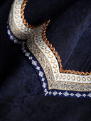 Close-up of the layered geometric neckline embroidery on midnight navy Xiangyunsha silk fabric