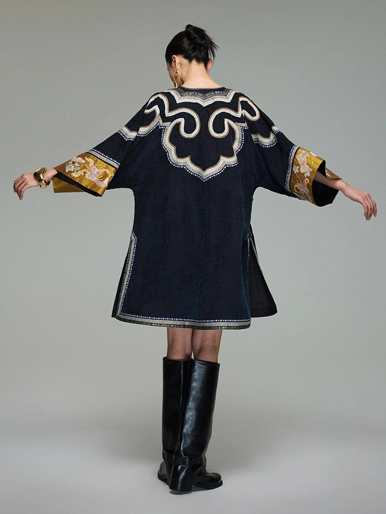 Back view of the loose Xiangyunsha silk dress showing ornate shoulder embroidery and wide three-quarter sleeves