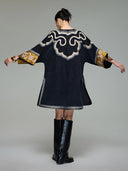 Back view of the loose Xiangyunsha silk dress showing ornate shoulder embroidery and wide three-quarter sleeves